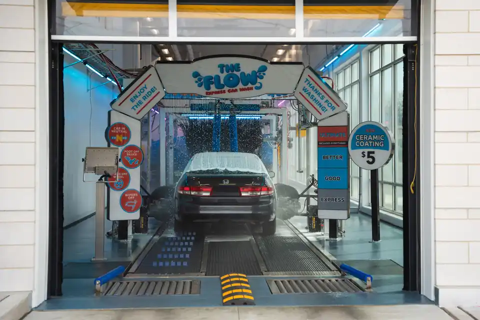 A car entering the wash tunnel at The Flow Express Car Wash in Naperville